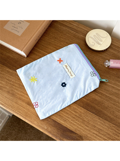 Blue rectangular pouch with scattered multicolored floral embroidery