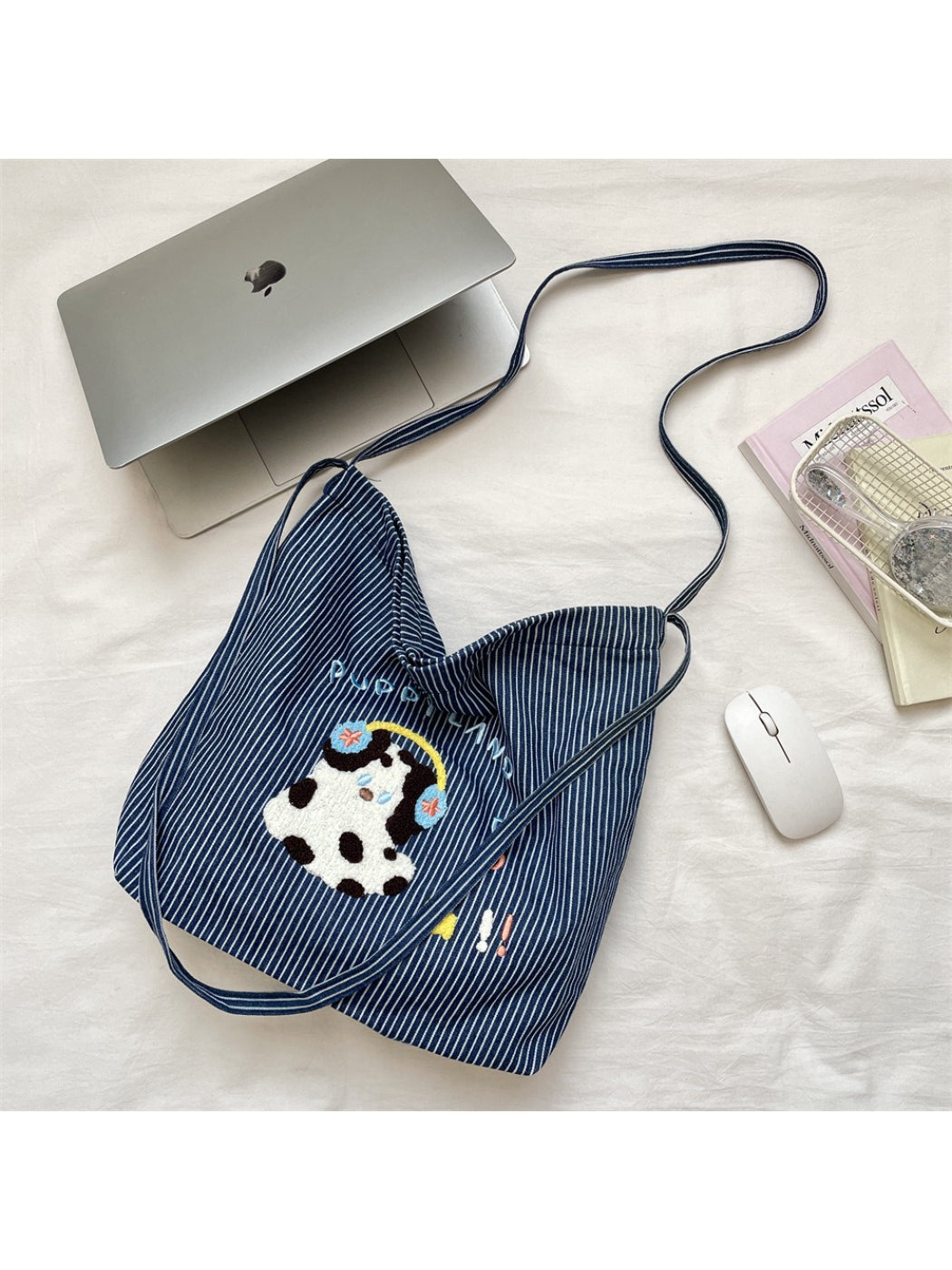 Striped tote bag with animal embroidery shown from side angle