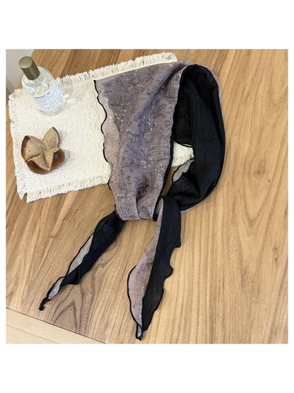 Botanical triangle scarf laid flat highlighting triangular shape and print