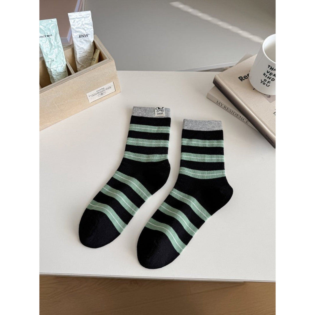 Model wearing Rufia contrast stripe knit crew socks with casual shoes