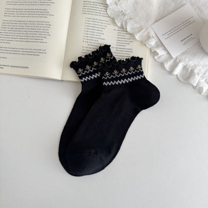 Pair of Rufia Sweet Frill Cuff Crew Socks laid flat highlighting the frill cuff design