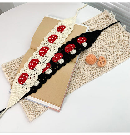 Haila crochet mushroom hairband held in hand to show size and flexibility
