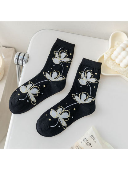 Rufia Painterly Flower Mixed Crew Socks displayed on wooden surface showing vibrant colors