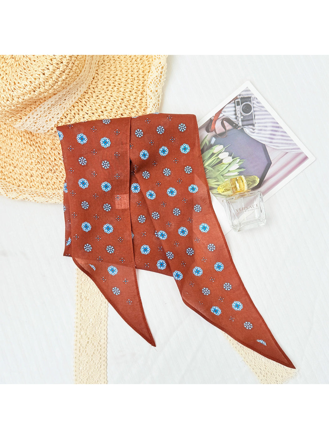 Scarvii printed triangle scarf tied around neck showing pattern details