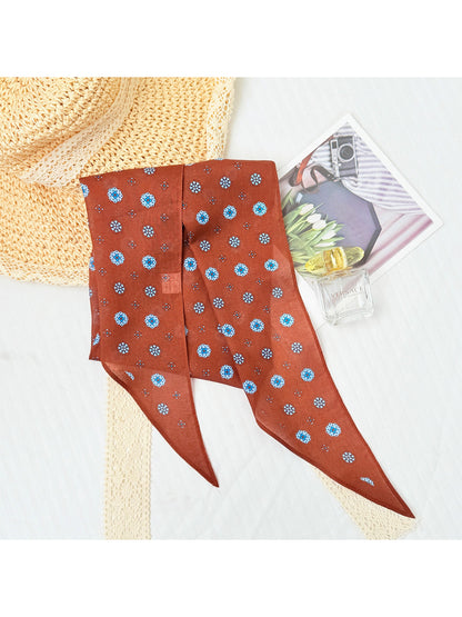 Scarvii printed triangle scarf tied around neck showing pattern details