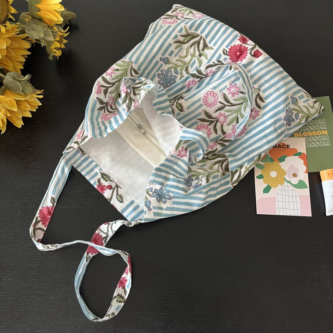 Side view of blue stripe floral tote bag showing depth and stitching details
