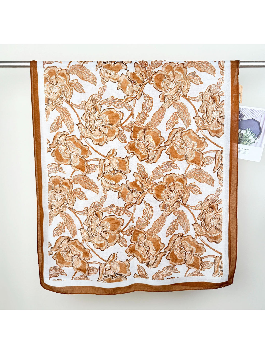 Scarvii wrap scarf folded to display vibrant floral design and soft fabric texture