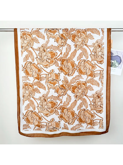 Scarvii wrap scarf folded to display vibrant floral design and soft fabric texture