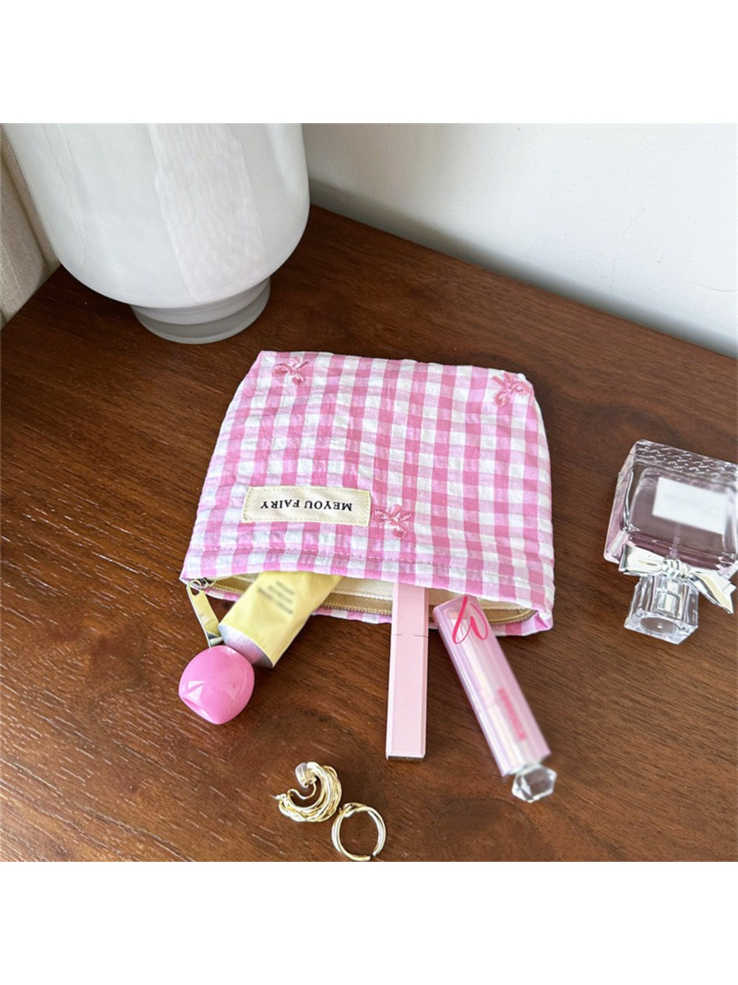 Cosbai pastel check zip pouch held in hand showing size and pattern