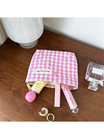 Cosbai pastel check zip pouch held in hand showing size and pattern