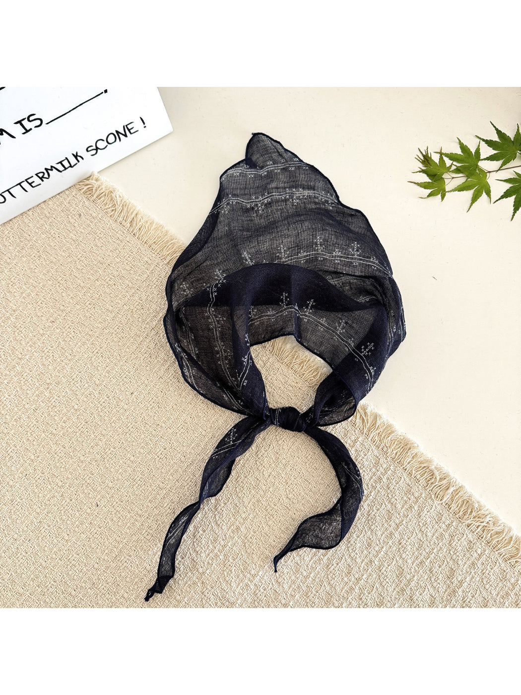 Scarvii lightweight textured tie head scarf tied around a ponytail on model