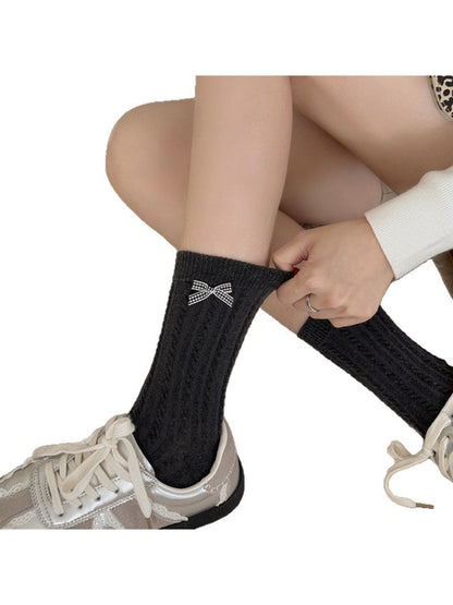 Pair of Rufia Classic Bow Trim Crew Socks in white with black bow detail