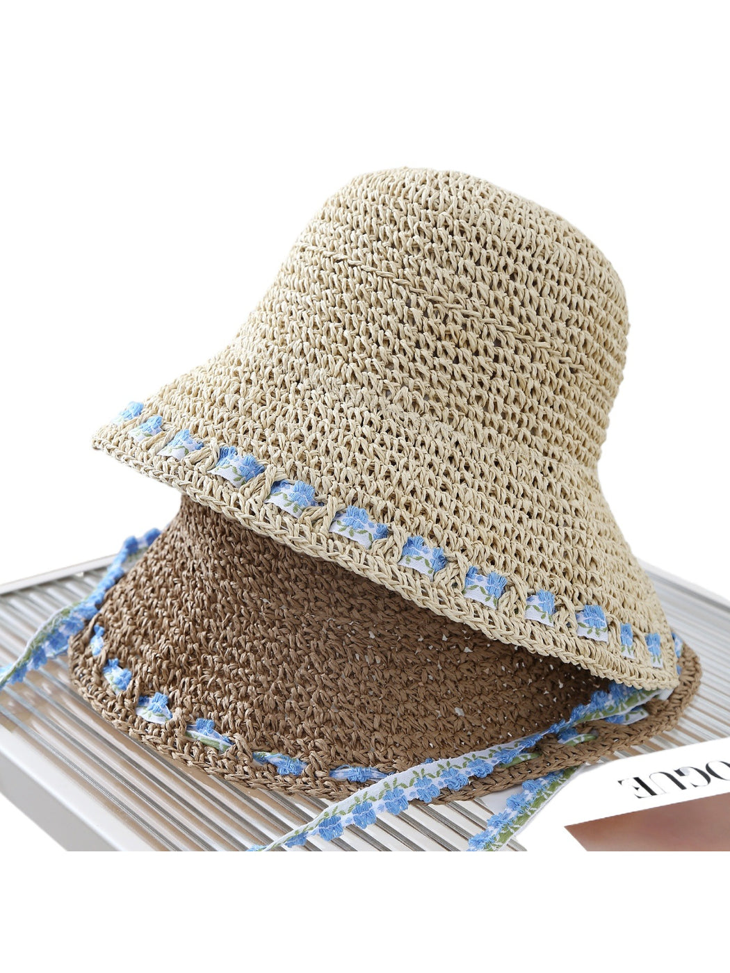 Haila floral trim straw bucket hat displayed on a white background