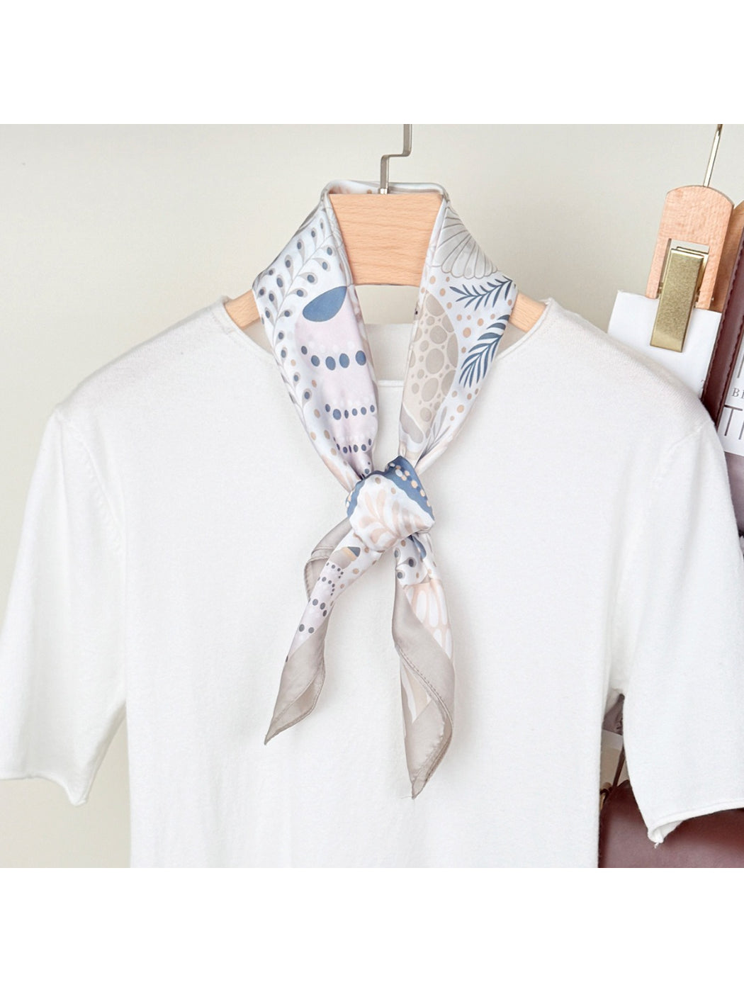 Close-up of Scarvii scarf fabric with seaside motifs including shells and starfish