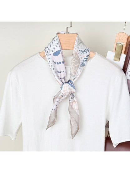 Close-up of Scarvii scarf fabric with seaside motifs including shells and starfish