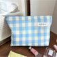 Close-up of Cosbai pastel check makeup pouch showing fabric texture