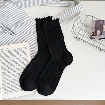 Model wearing white ruffle trim crew socks with casual shoes