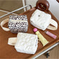 Cosbai soft handle cosmetic bag in a neutral color on a white background