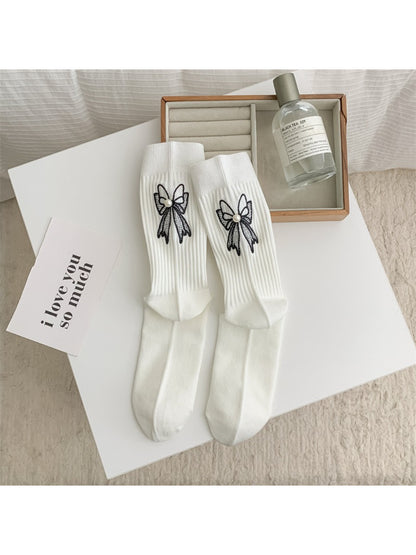 Side view of Rufia everyday crew sock highlighting bow accent and ribbed texture