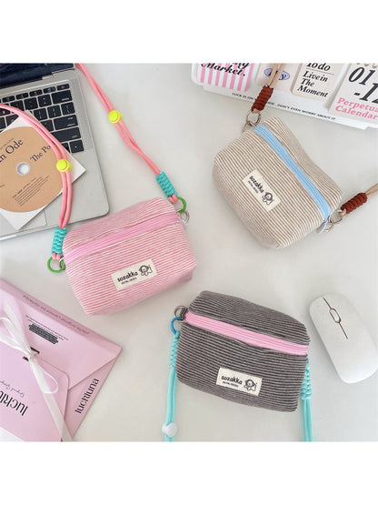Cosbai striped mini crossbody pouch with black and white horizontal stripes on a white background