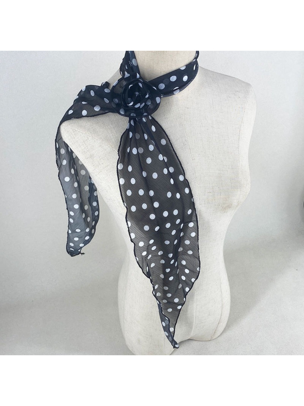 Model styling scarf as a headband with vintage polka dot rose print
