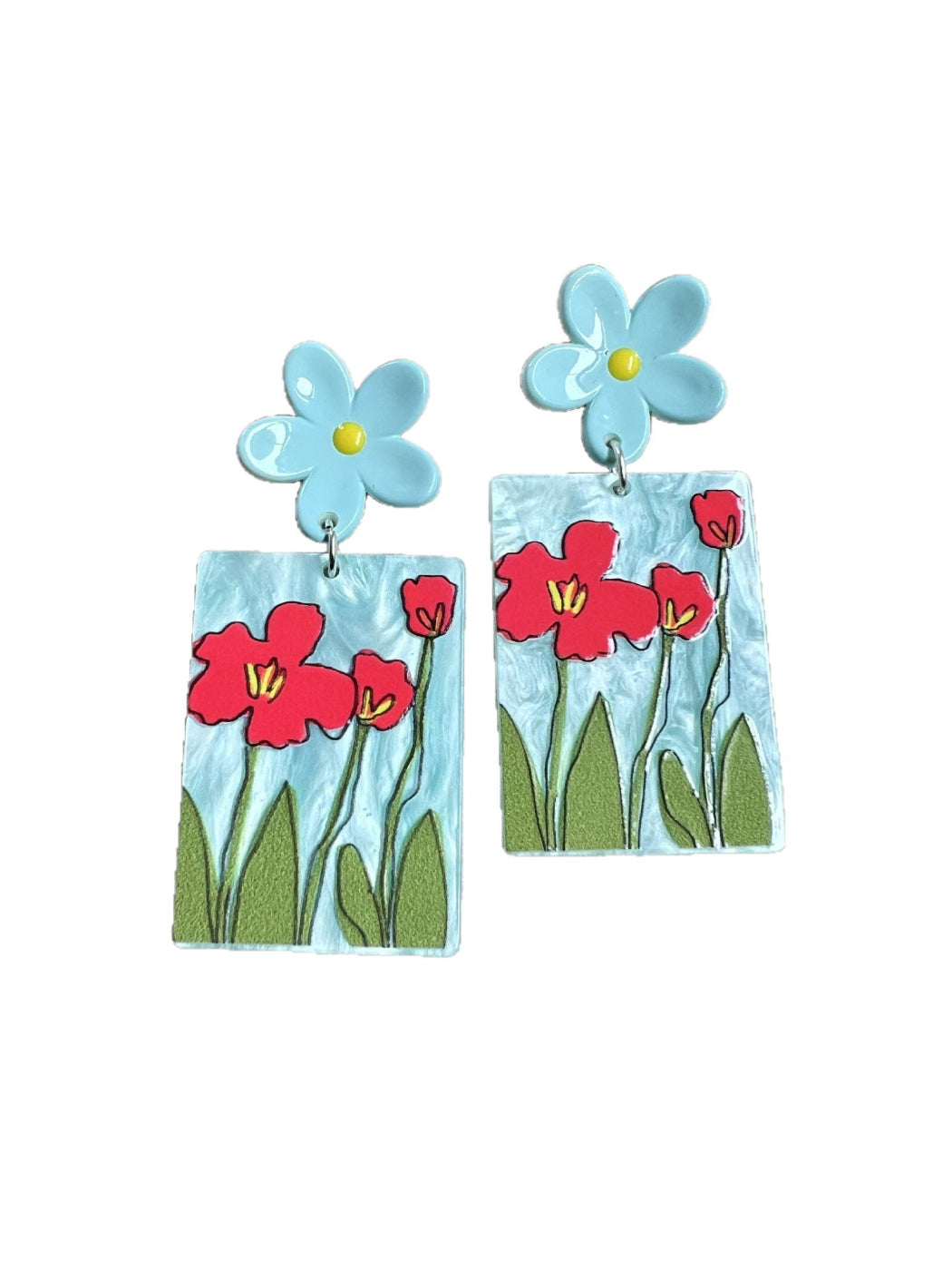 Pair of Earwish Painted Flower Drop Earrings laid flat on a wooden surface