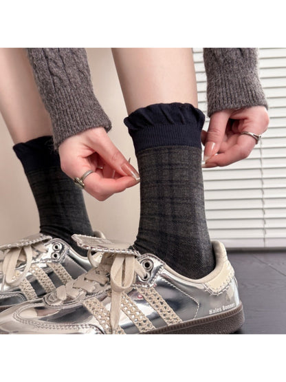 Pair of Rufia lace contrast mid-calf socks laid out with lace edges visible