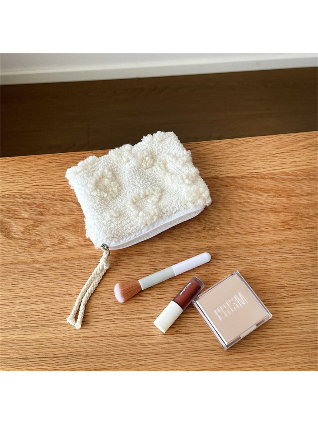 Red plush heart pouch displayed on a white surface with soft lighting