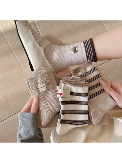 Pair of Rufia casual neutral crew socks displayed flat on a white background