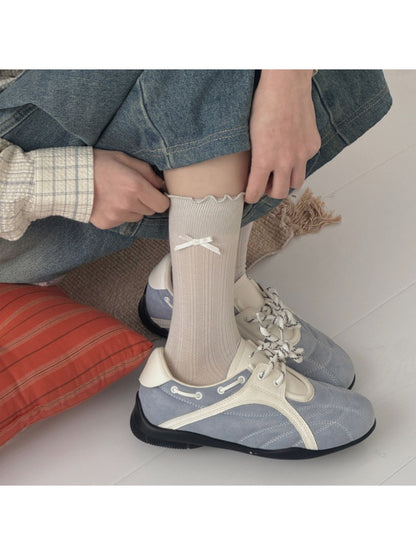 Rufia socks displayed flat highlighting the bow and frill design on the cuff
