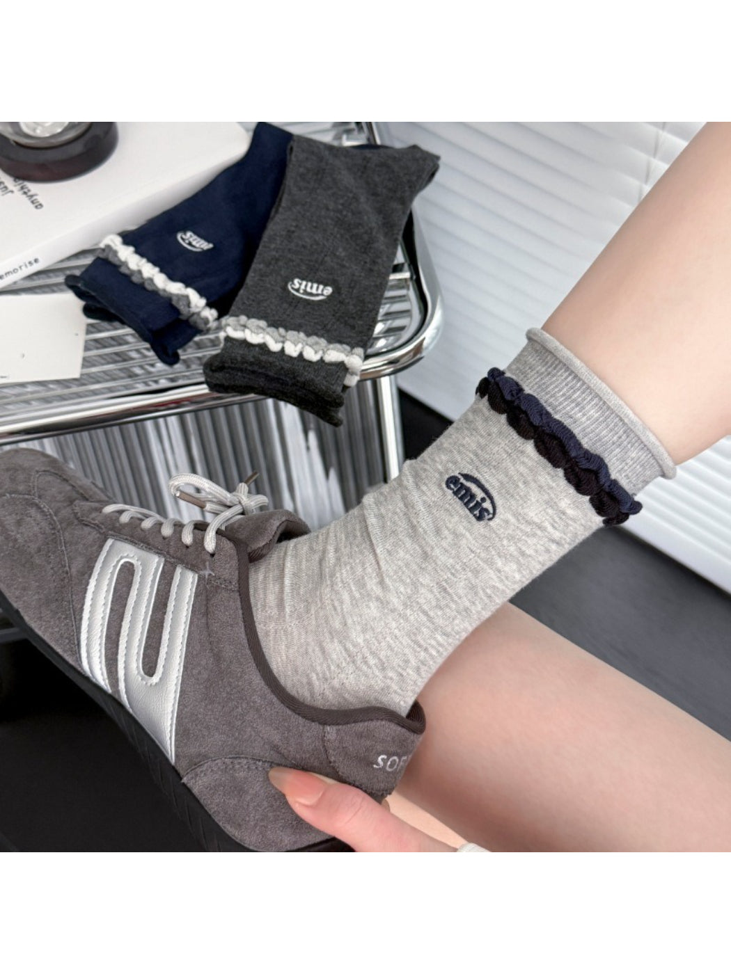 Rufia contrast braid knit socks worn with rolled-up jeans and brown shoes