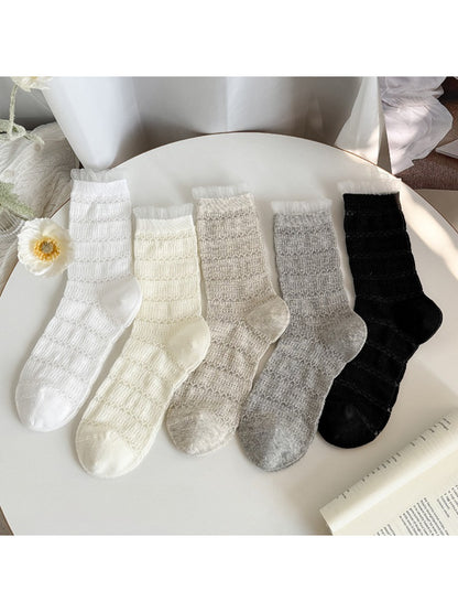 Close-up of Rufia textured everyday ruffle socks in beige with ruffled cuff