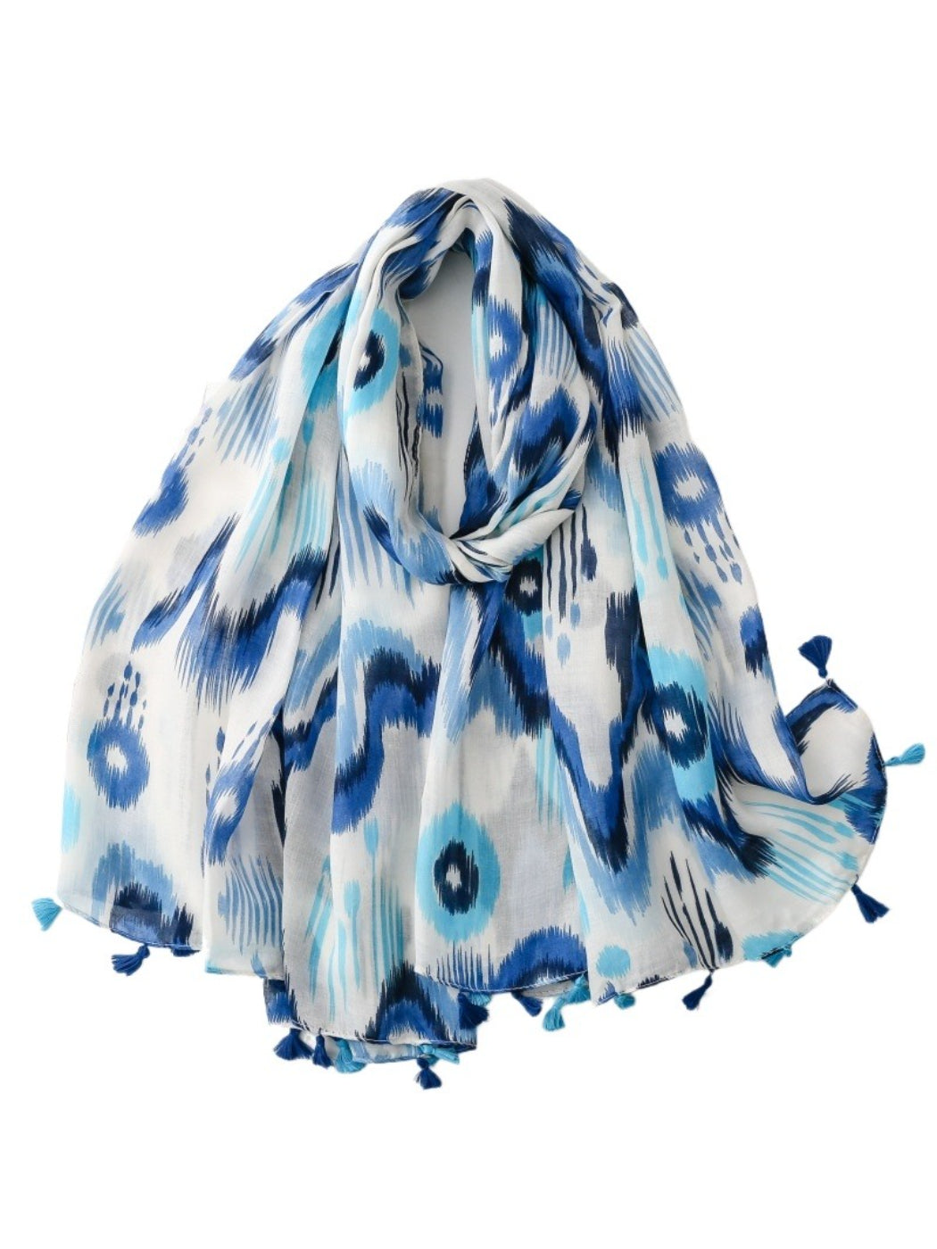 Model wearing Scarvii Boho Ikat Tassel Wrap styled as a shawl outdoors