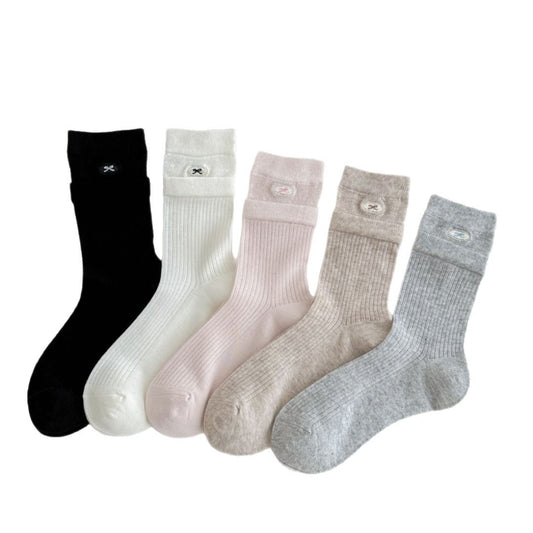 Pair of Rufia soft turnover cuff ribbed socks in beige laid flat