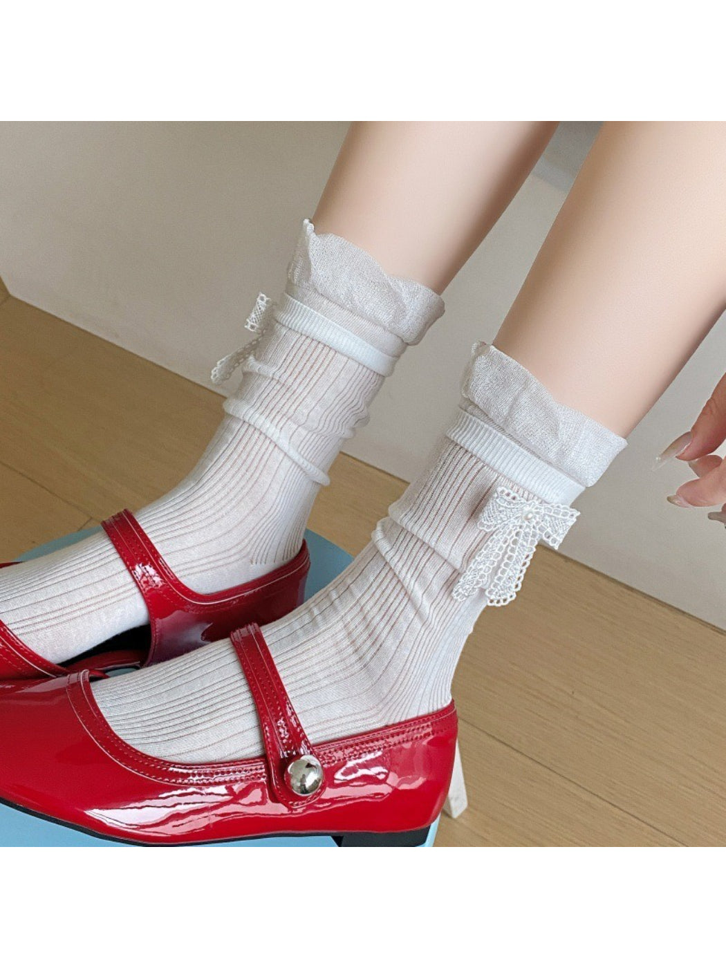 Close-up of pink ribbon trim on white Rufia crew socks
