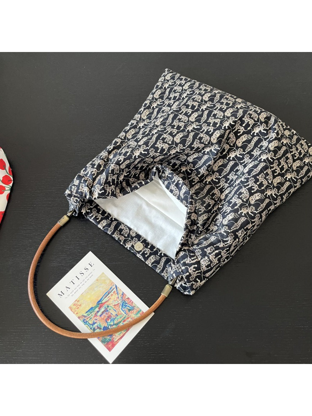 Side view of Cosbai black shoulder bag showing strap and cat print