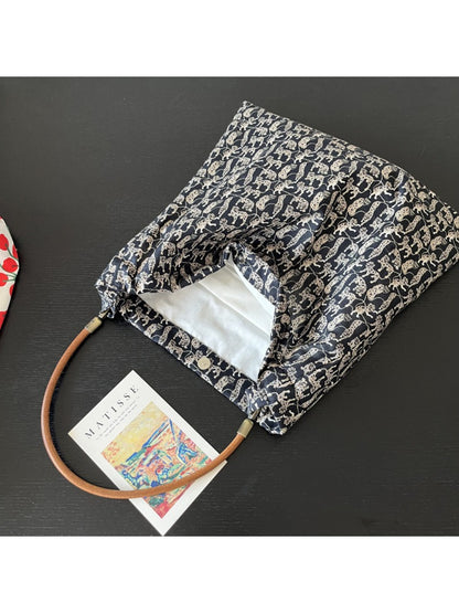 Side view of Cosbai black shoulder bag showing strap and cat print