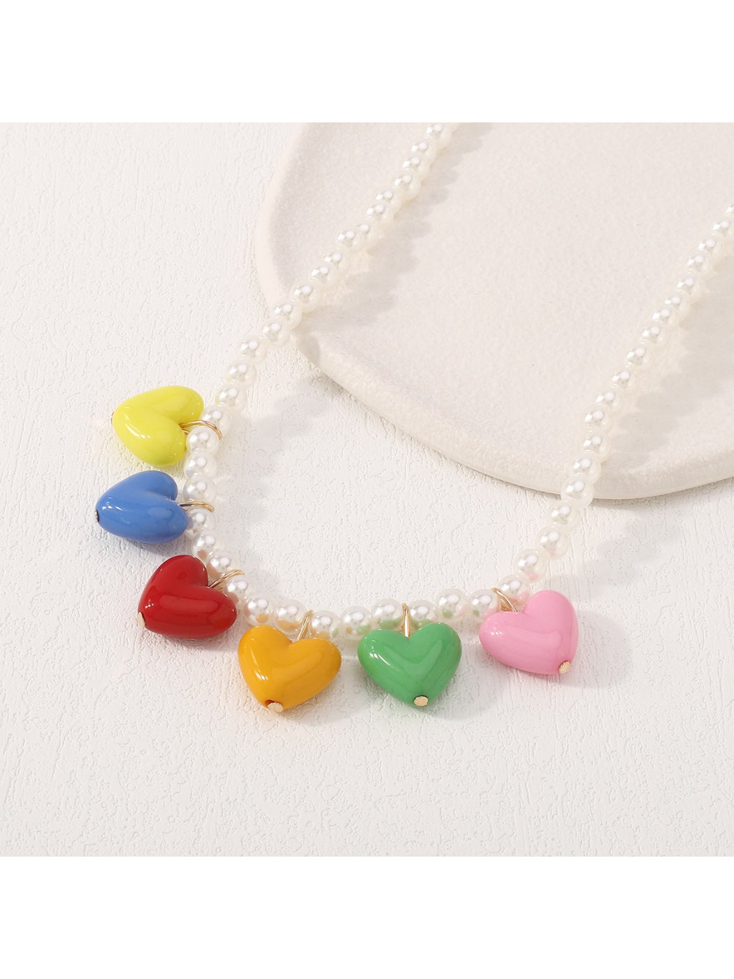 Neckit colourful heart charm necklace laid flat highlighting charm colors