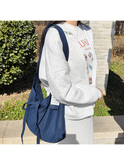 Side view of Cosbai slouchy tie shoulder bag showing soft texture