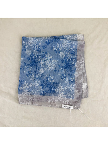 Scarvii scarf laid flat displaying full square shape and floral border print