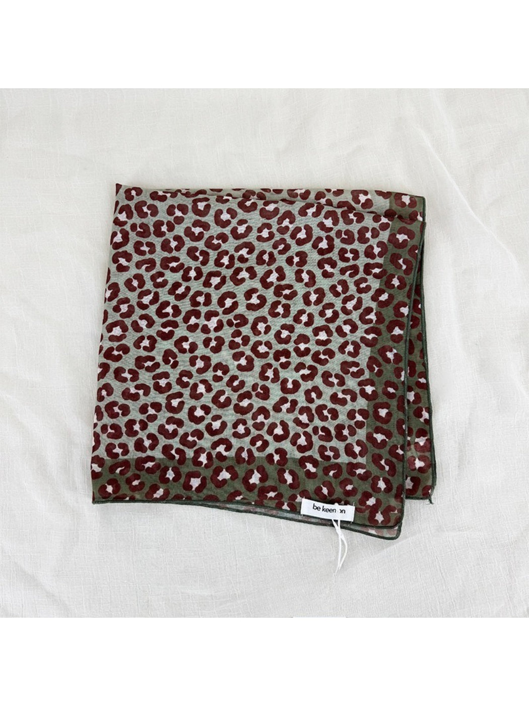 Close-up of Scarvii leopard print square scarf fabric and print details