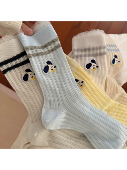 Model wearing Rufia Playful Pup Everyday Socks with casual shoes and jeans