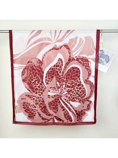 Scarvii scarf draped over shoulders highlighting vibrant leopard and flower print