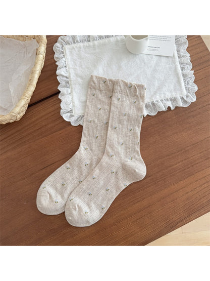 Rufia socks folded neatly showing floral design and soft texture