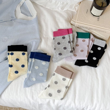Rufia mid-calf socks worn on feet showing dot pattern and color block contrast