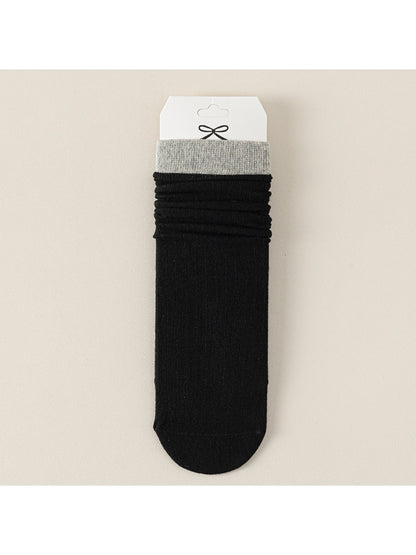 Rufia ribbed mid-calf socks for women in black displayed flat on white background
