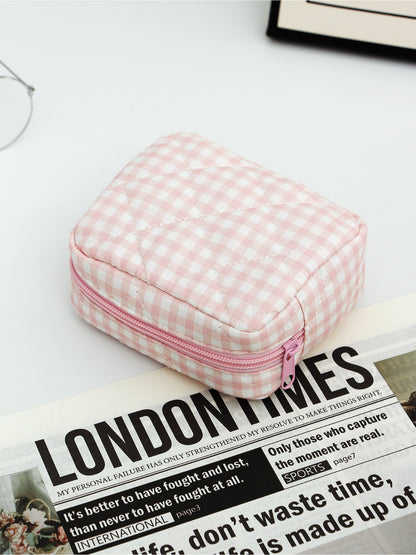 Cosbai checkered makeup pouch trio with ruffle trim stacked on top of each other