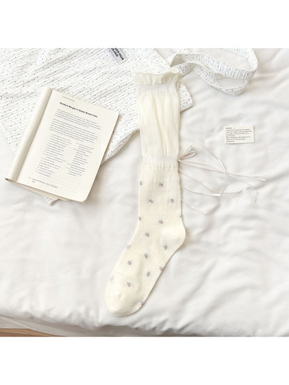 Close-up of Rufia Soft Bloom Ruffle Crew Socks showing delicate floral design and soft fabric texture