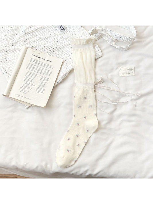 Close-up of Rufia Soft Bloom Ruffle Crew Socks showing delicate floral design and soft fabric texture