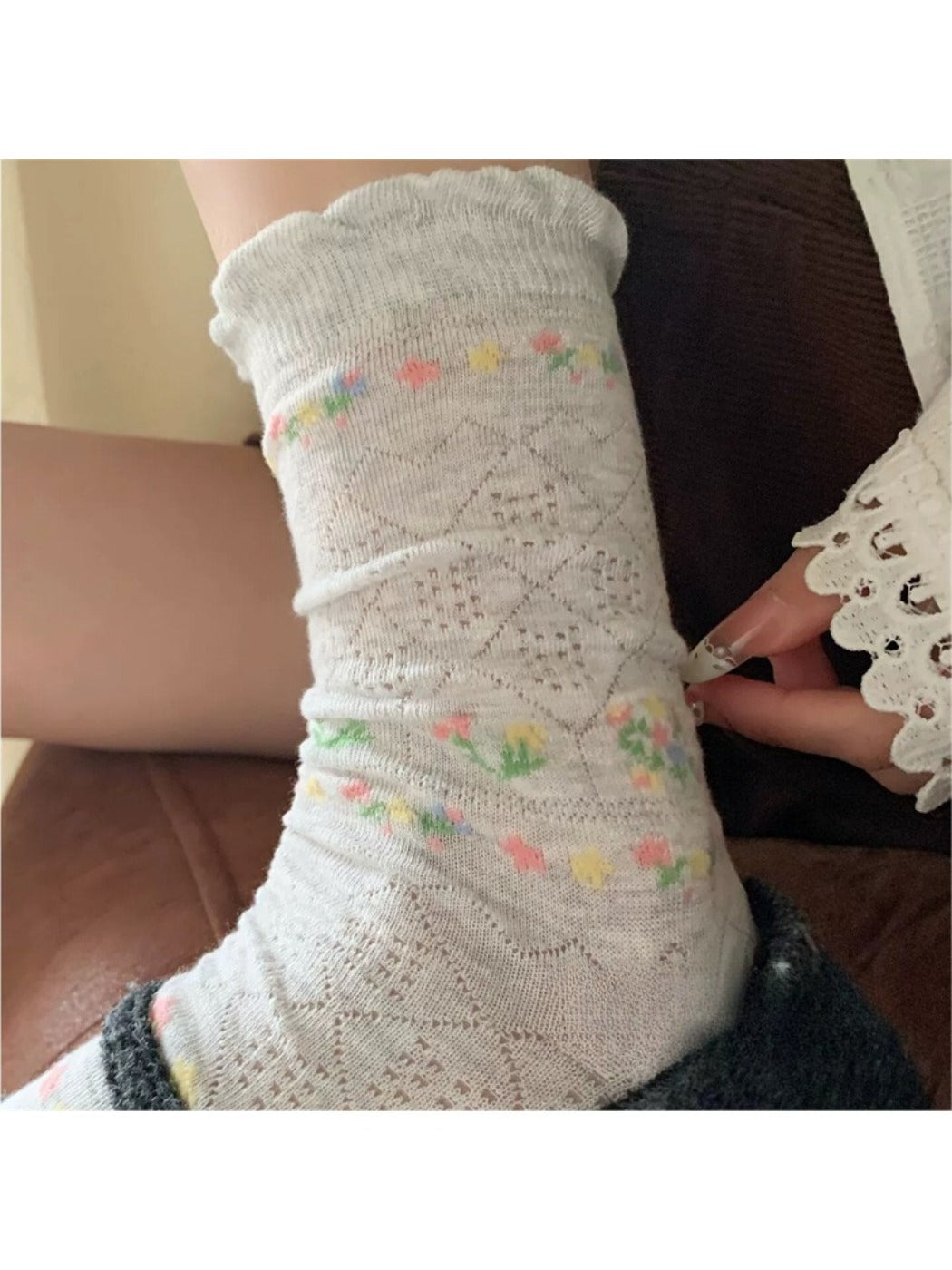 Side view of Rufia floral pointelle crew socks highlighting ribbed cuff and floral pattern